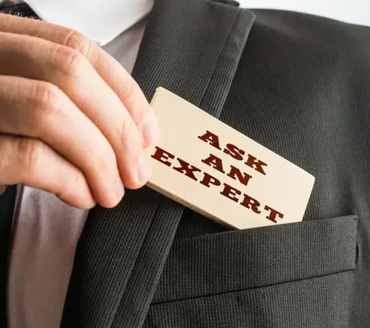 Man pulling out a card saying Ask an Expert