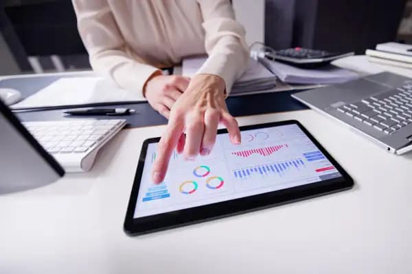 person pointing at a tablet screen